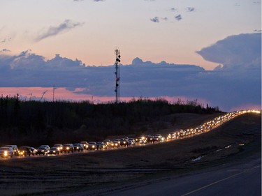 Traffic lines the highway as residents leave Fort McMurray, Alta., on Tuesday May 3, 2016. A wildfire has put all of Fort McMurray under a mandatory evacuation order which means that about 70,000 people who live in Fort McMurray are being told to flee the city.