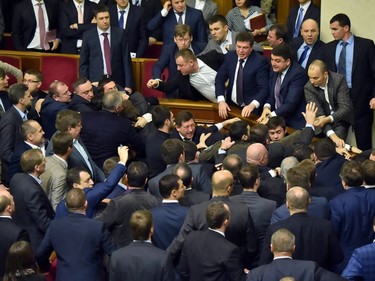 Deputies of Ukrainian Parliament fight after the attack of the Ukrainian Prime Minister during the annual report of the government in Ukrainian Parliament on December 11, 2015.