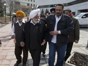 Ajit Singh father of Jagtar Gill (Centre) is comforted by supporters in this 2014 file photo.