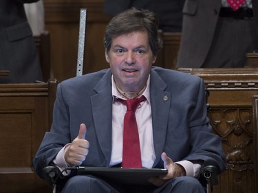 Ottawa-Vanier MP Mauril Belanger, who lives with ALS (also known as Lou Gherig's disease) gives the thumbs up as he receives applause after using a tablet with text-to-speech program to defend his proposed changes to neutralize gender in the lyrics to "O Canada" in the House of Commons on Parliament Hill in Ottawa on Friday, May 6, 2016.