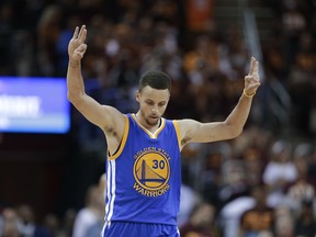 Golden State Warriors guard Stephen Curry (30) celebrates a basket against the Cleveland Cavaliers during the second half of Game 4 of basketball's NBA Finals in Cleveland, Friday, June 10, 2016.