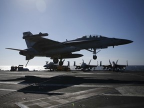 A US Navy F/A-18 Super Hornet fighter lands onto the deck of the USS Ronald Reagan, a Nimitz-class nuclear-powered aircraft carrier, during a joint naval drill between South Korea and the US in the West Sea off South Korea on October 28, 2015.