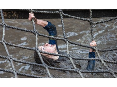 A competitor makes her way through an obstacle as the Mud Hero Ottawa 2016 continued on Sunday at Commando Paintball located east of Ottawa.