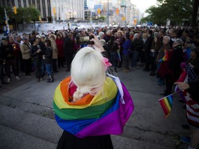 A large group gathered at the Human Rights Monument on Elgin Street on Sunday, June 12, 2016 for a vigil after the mass shooting in Orlando at Pulse, a gay nightclub. Christie Millen, known as Koston Kreme, a well-known burlesque performer in the Ottawa area, takes a photo of the crowd.