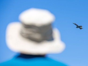 A tilly hat was appropriate for the bright sunshine as the CF 18 performs a fly past as Vintage Wings of Canada put on their annual Wings Over Gatineau Airshow.