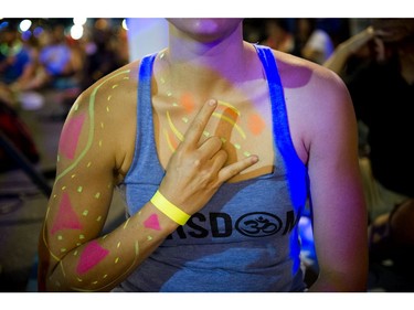 A woman was all decked out with coloured paint at Glowfair Festival during the yoga class Friday June 17, 2016.