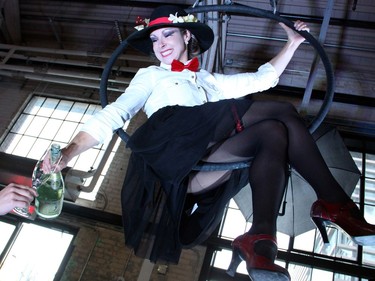 Aerialist Karin Arseneault, as a suspended, umbrella-carrying, hat-wearing Mary Poppins, poured Barefoot Bubbly for guests at the British-themed Bash 2016: London Calls fundraiser for the Snowsuit Fund, held Friday, June 10, 2016, at the Horticulture Building at Lansdowne.