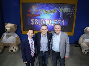 Alex Munter, left, Graham Richardson, centre, and Kevin Keohane, chief operating officer, CHEO Foundation, pose for a photo with the final tally of $8,013,771 at the CHEO Telethon at the EY Centre in Ottawa on Sunday, June 5, 2016.
