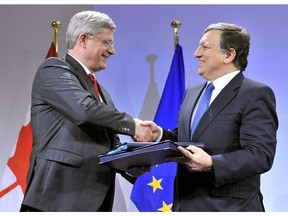 European Commission President Jose Manuel Barroso (R) shakes hand with then-prime minister Stephen Harper during a signing ceremony of a free-trade accord in 2013 at the EU headquarters in Brussels. Almost three years later, the deal seems stalled.