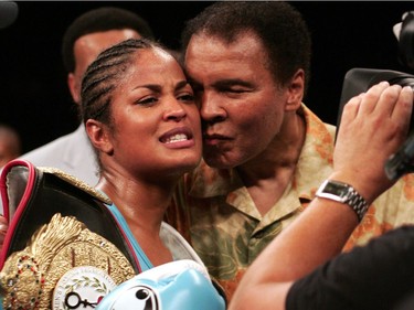 WIBA Super Middleweight Champion Laila Ali is kissed by her father, boxing legend Muhammad Ali, following her third round TKO victory over Erin Toughill  11 June 2005 at the MCI Center in Washington, DC.