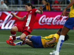 Brazil's Bruna, right,  slide tackles Diana Matheson in scoring position during a friendly women's soccer match at TD Place Tuesday June 07, 2016.