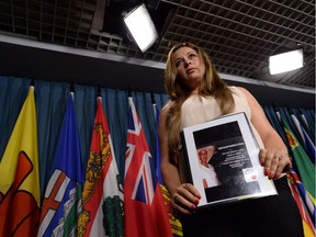 Mexican human rights defender Brenda Rangel Ortiz holds a picture of her missing brother as she takes part in a press conference on Parliament Hill in Ottawa.
