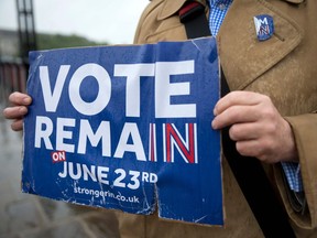 Campaigners hold placards for 'Britain Stronger in Europe', the official 'Remain' campaign group seeking to avoid a Brexit, ahead of the forthcoming EU referendum, in London on June 20, 2016.  /