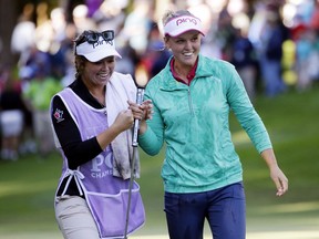 Brooke Henderson, right, walks off the 18th green with her sister and caddy Brittany Henderson after winning the Women's PGA Championship golf tournament at Sahalee Country Club Sunday, June 12, 2016, in Sammamish, Wash.