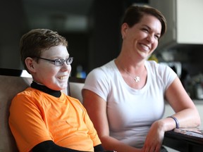"Butterfly Child" Jonathan Pitre, 16, is the first Canadian to undergo a bone-marrow transplant developed in the US to dramatically improve the devastating symptoms of his Epidermolysis Bullosa (EB). He is pictured here with his mother, Tina Boileau, in September.