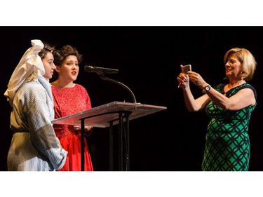 Carol Anne Meehan (R), host 1310 NEWS, records the award winners for Critic's Play, during the 11th annual Cappies Gala awards, held at the National Arts Centre, on June 5, 2016.