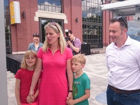 Catherine McKenna, minister of environment and climate change, views a climate change exhibit along with her two children and Alex Benay, CEO of Canada Science and Technology Museums Corporation. McKenna unveiled the exhibit at Lansdowne Park on Saturday, June 4, 2016.