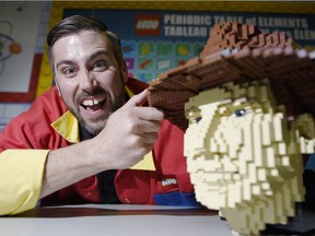 Chris Steininger, a Lego master builder, is photographed by a model of Indiana Jones at the Lego Imagine Nation Tour at the EY Centre on Friday June 10, 2016.