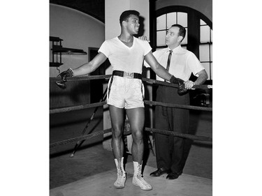 FILE - In this Feb. 8, 1962, file photo, young heavyweight fighter Cassius Clay, who later changed his name to Muhammad Ali, is seen with his trainer Angelo Dundee at City Parks Gym in New York. Dundee, the peerless trainer who was in the corner for Muhammad Ali and Sugar Ray Leonard and always drew the best out of his fighters, died on Feb. 1, 2012. He was 90.