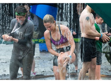 Competitors wash off the mud at the end as the Mud Hero Ottawa 2016 continued on Sunday at Commando Paintball located east of Ottawa.