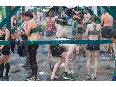 Competitors wash off the mud at the end as the Mud Hero Ottawa 2016 continued on Sunday at Commando Paintball located east of Ottawa.