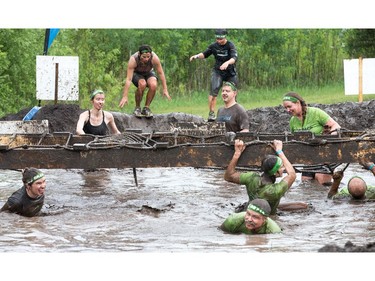 Competitors work their way through an obstacle as the Mud Hero Ottawa 2016 continued on Sunday at Commando Paintball located east of Ottawa.