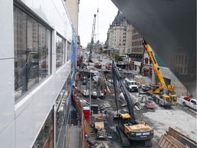 Work continued Saturday on the Rideau Street sinkhole seen here from the Rideau Centre pedestrian bridge. (Blair Crawford/Postmedia)