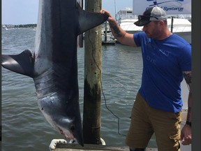 Coun. Jody Mitic poses with a mako shark he helped catch as part of a charity tournament for wounded veterans.