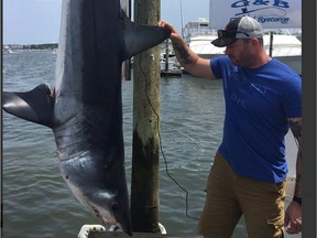 Coun. Jody Mitic poses with a mako shark he helped catch as part of a charity tournament for wounded veterans.