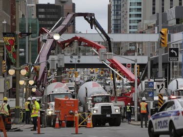 Crews worked into the evening to fill in the sinkhole that opened up this morning just east of the intersection of Rideau Street and Sussex Drive, which caused a gas leak and building evacuations, on June 8, 2016. (David Kawai)