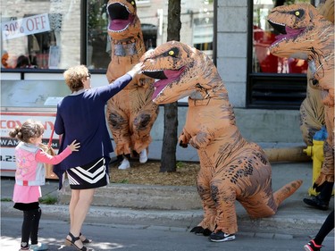 Dinosaurs seemed to be taking over in downtown Ottawa as a pack of large, wobbling meat eaters wandered around the Byward Market Tuesday (June14, 2016).  The dinos, which took some by surprise, but mostly gave people a pretty cool selfie, were out to promote the Ultimate Dinosaurs exhibit, which runs at  the Canadian Museum of Nature from June 11 to Sept. 5th. JULIE OLIVER/POSTMEDIA