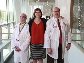Dr. Harry Atkins, Jennifer Molson and Dr. Mark Freedman pose for a photo at The Ottawa Hospital.