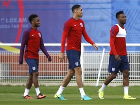 England's Raheem Sterling, left, England's Chris Smalling, centre, and England's Daniel Sturridge, right, arrive for a training session in Chantilly, France, Sunday, June 26, 2016.