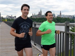 Prime Minister Justin Trudeau and Mexican President Enrique Pena Nieto run across the Alexandra Bridge from Ottawa to Gatineau, Quebec on Tuesday, June 28, 2016.