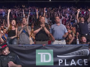 Fans cheer their favourite at UFC Fight NIght at TD Place Arena Saturday.