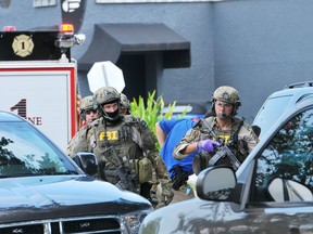 FBI, Orlando Police Department and the Orange County Sheriff's Office personnel investigate the attack at the Pulse nightclub in Orlando Fla., Sunday, June 12, 2016.
