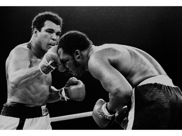 FILE - In this Oct. 1, 1975, file photo, Muhammad Ali's throws a right at Joe Frazier in the 13th round in their title bout in Manila, Philippines. Ali, the magnificent heavyweight champion whose fast fists and irrepressible personality transcended sports and captivated the world, has died according to a statement released by his family Friday, June 3, 2016. He was 74.