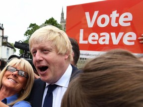 In this Wednesday, June 22, 2016 file photo, advocate to exit Europe Boris Johnson poses for a selfie photo with voters during a whistle stop tour of the country on the final day of campaigning before Thursday's EU referendum vote, in Selby, north England.