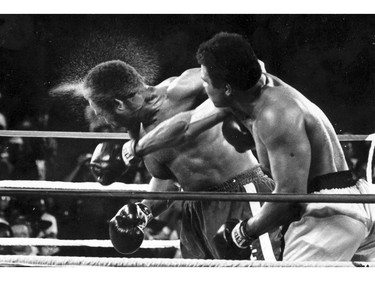 FILE - This is a Oct. 30, 1974,  file photo showing George Foreman taking a right to the head from challenger Muhammad Ali in the seventh round in the match dubbed Rumble in the Jungle in Kinshasa, Zaire. Ali, the magnificent heavyweight champion whose fast fists and irrepressible personality transcended sports and captivated the world, has died according to a statement released by his family Friday, June 3, 2016. He was 74.