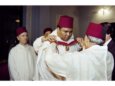 (FILES) This file photo taken on January 15, 1998 shows Moroccan King Hassan II (R) decorating former World Heavyweight Champion Muhammad Ali during a ceremony in the Royal Palace in Rabat. Boxing icon Muhammad Ali died on Friday, June 3, a family spokesman said in a statement. "After a 32-year battle with Parkinsons disease, Muhammad Ali has passed away at the age of 74," spokesman Bob Gunnell said. /