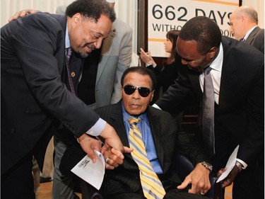 (FILES) This file photo taken on May 24, 2011 shows Legendary heavyweight boxing champion Muhammad Ali (C) is greeted after a news conference at the National Press Club in Washington. Boxing icon Muhammad Ali died on Friday, June 3, a family spokesman said in a statement. "After a 32-year battle with Parkinsons disease, Muhammad Ali has passed away at the age of 74," spokesman Bob Gunnell said. /
