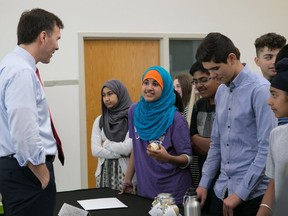 Finance Minister Bill Morneau talks with Grade 8 students from Longfields-Davidson Heights Secondary School.