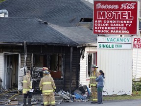 Firefighters at the scene of a fire at the Beacon Hill Motel on Montreal Road in Ottawa on Sunday, June 12, 2016.