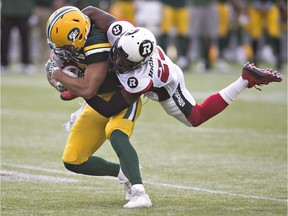 Ottawa Redblacks Forrest Hightower (23) tackles Edmonton Eskimos Nate Coehoorn (85) during second half CFL action in Edmonton, Alta., on Saturday, June 25, 2016.