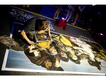 Francois Pelletier woks on his pavement art along Bank Street at Glowfair Festival Friday June 17, 2016.