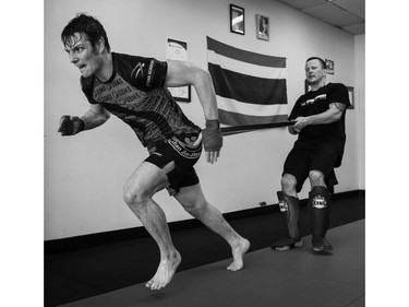 Fred Stonehouse, left, works with Kru Jeff Harrison at the Ottawa Academy of Martial Arts Thursday, May 19, 2016 in preparation for his professional mixed martial arts fight June 4, 2016 in Pittsburgh, Pennsylvania.  (Darren Brown).