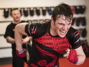 Fred Stonehouse, right, works with Kru Jeff Harrison at the Ottawa Academy of Martial Arts in preparation for his professional mixed martial arts fight in Pittsburgh.