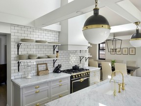 Trendy but classic- this kitchen by Tanya Collins brings in trends such as subway tile- flooring that is light- wide-planked and a matte finish- and marble and gold touches.