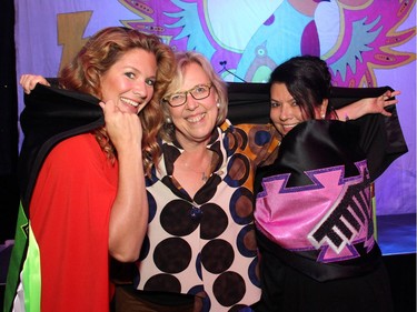 Green Party leader Elizabeth May, centre, wraps her live auction purchase -- a new traditional Thunderbird shawl -- around guest speaker Sophie Grégoire Trudeau, left, and Allison Fisher, executive director of the Wabano Centre, at the Igniting the Spirit Gala held at the Ottawa Conference and Event Centre on Tuesday, June 21, 2016.