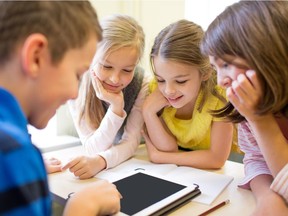 education, elementary school, learning, technology and people concept - group of school kids with tablet pc computer having fun on break in classroom 

child tablet